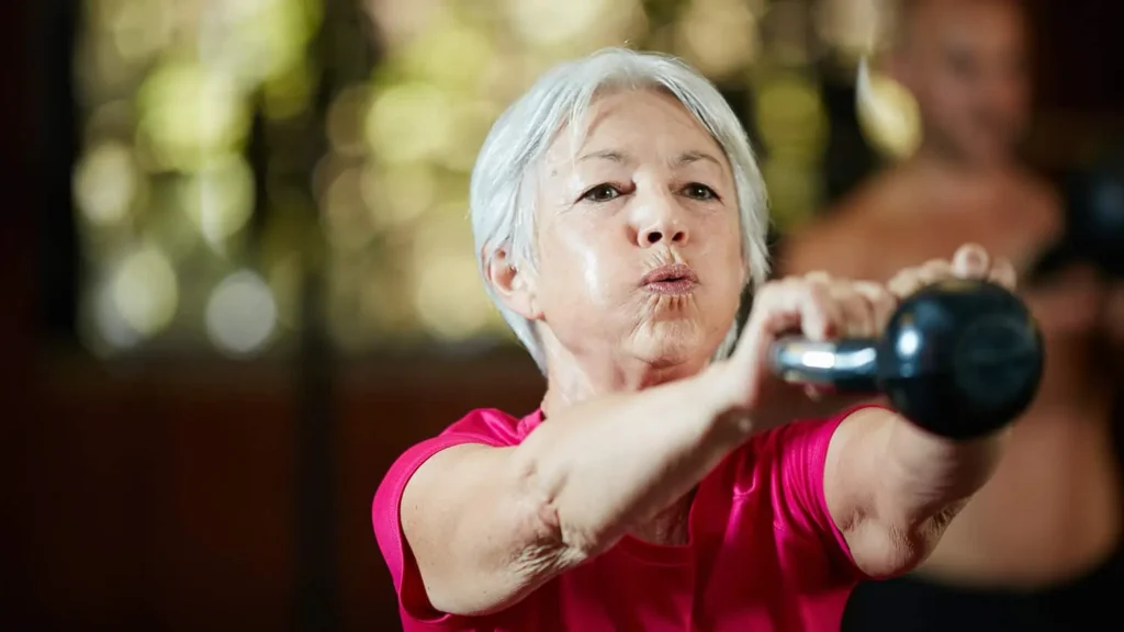 Toning Arms Without the Bulk: Is It Achievable? 1 Woman doing resistance band exercises for toned arms Southall